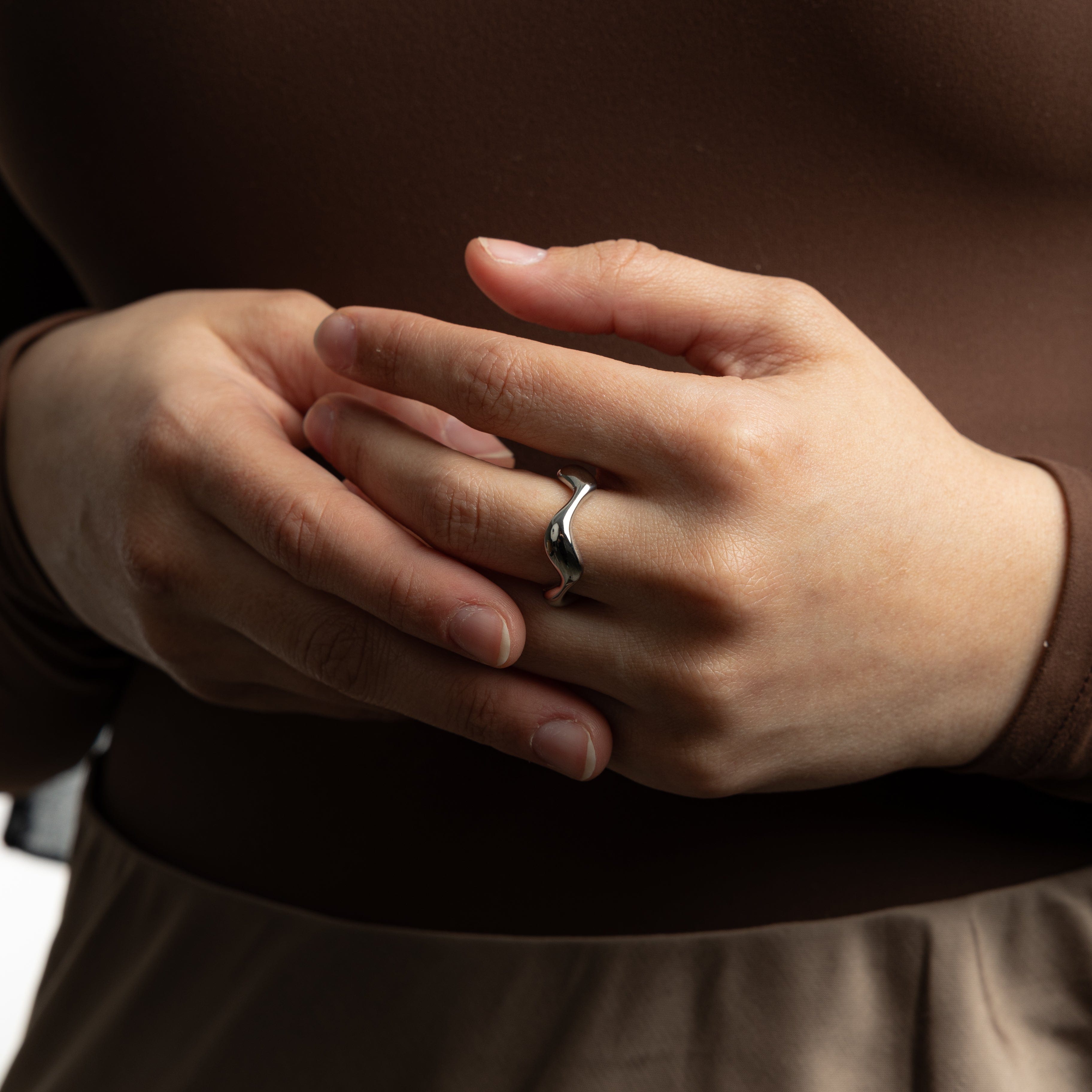 Oceanic Wave Gold Ring displayed in a velvet pouch, highlighting its elegant packaging.