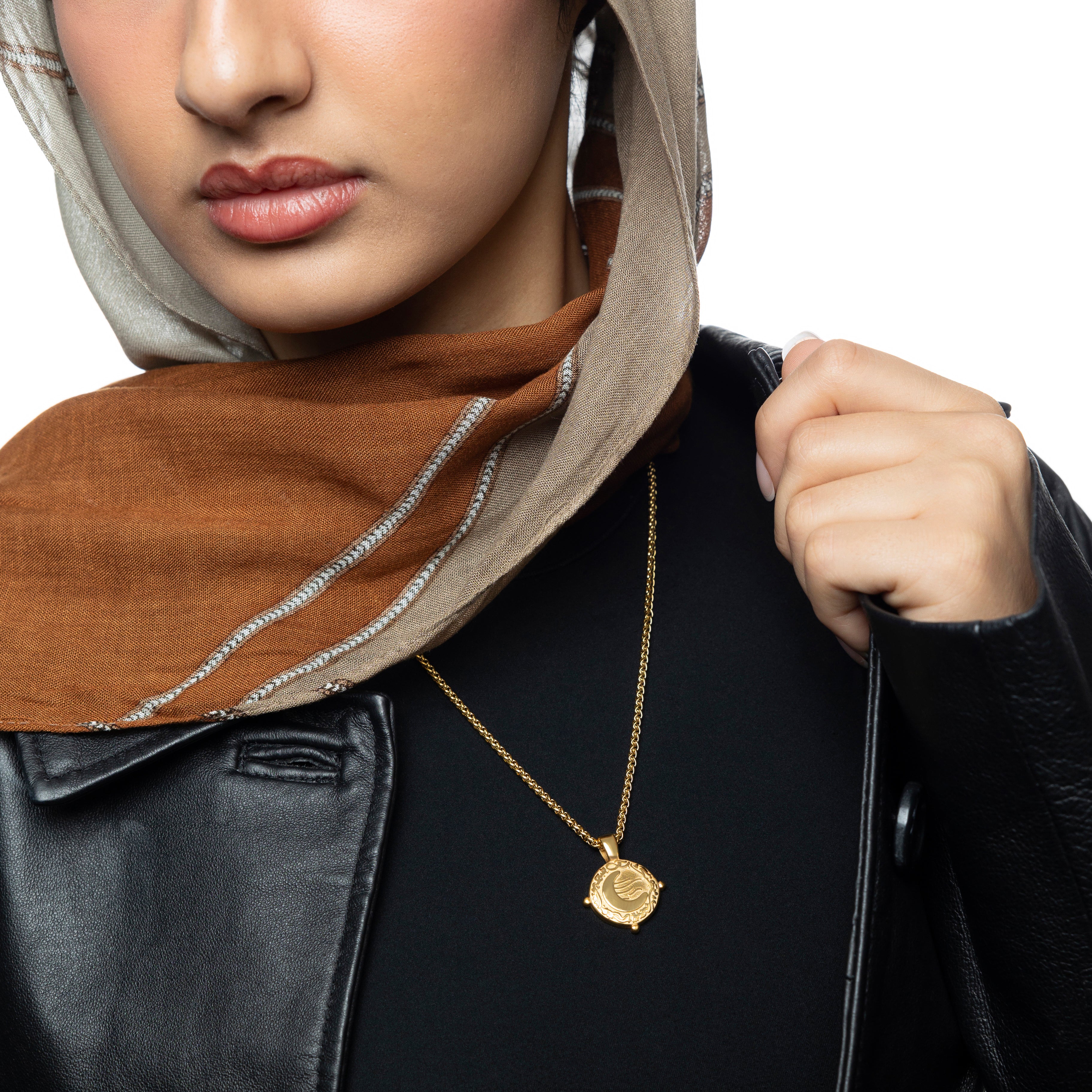 Close-up view of the vintage gold crescent necklace showcasing the Arabic pendant.