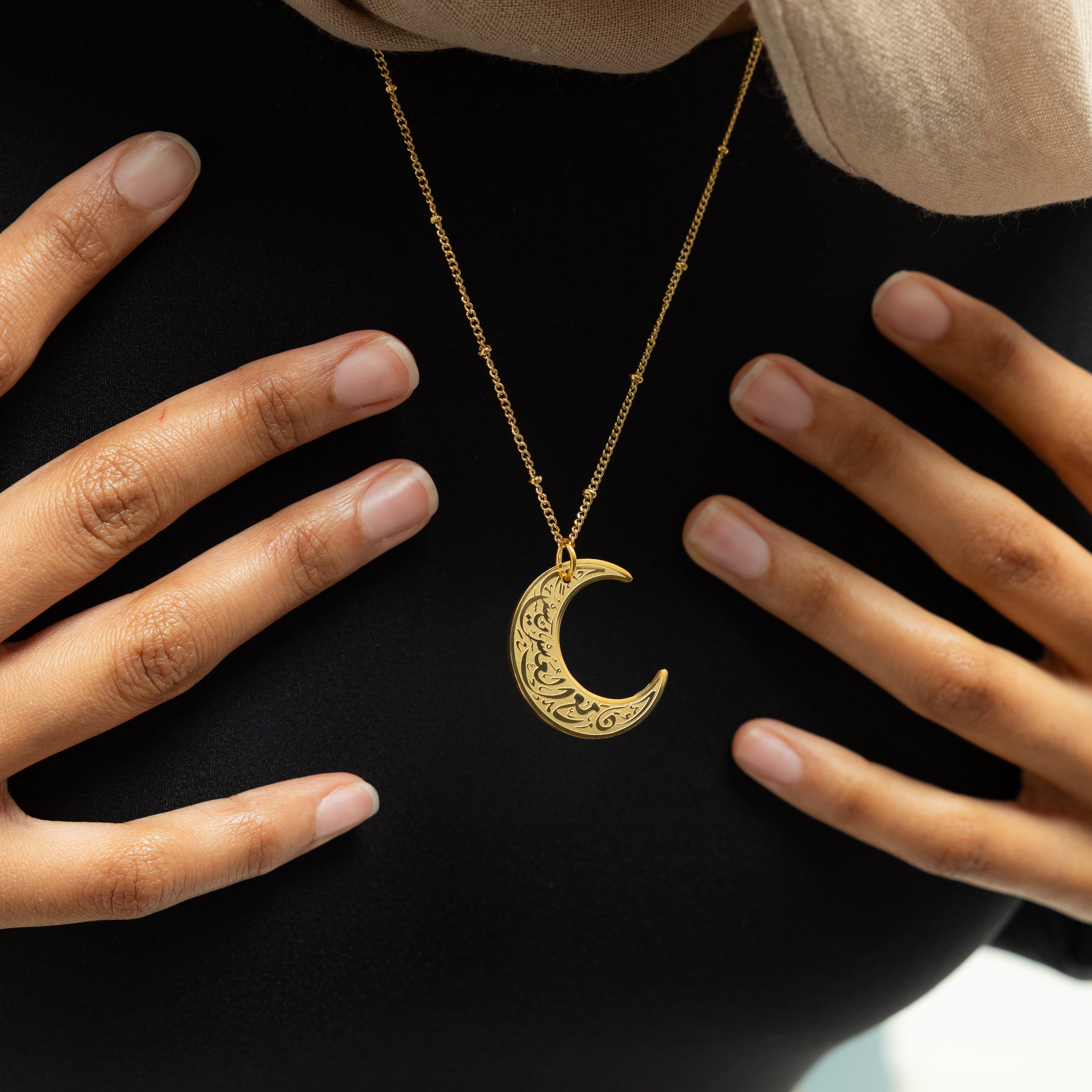 Close-up of the Crescent of Resilience Necklace showcasing the intricate details of the Quranic verse.