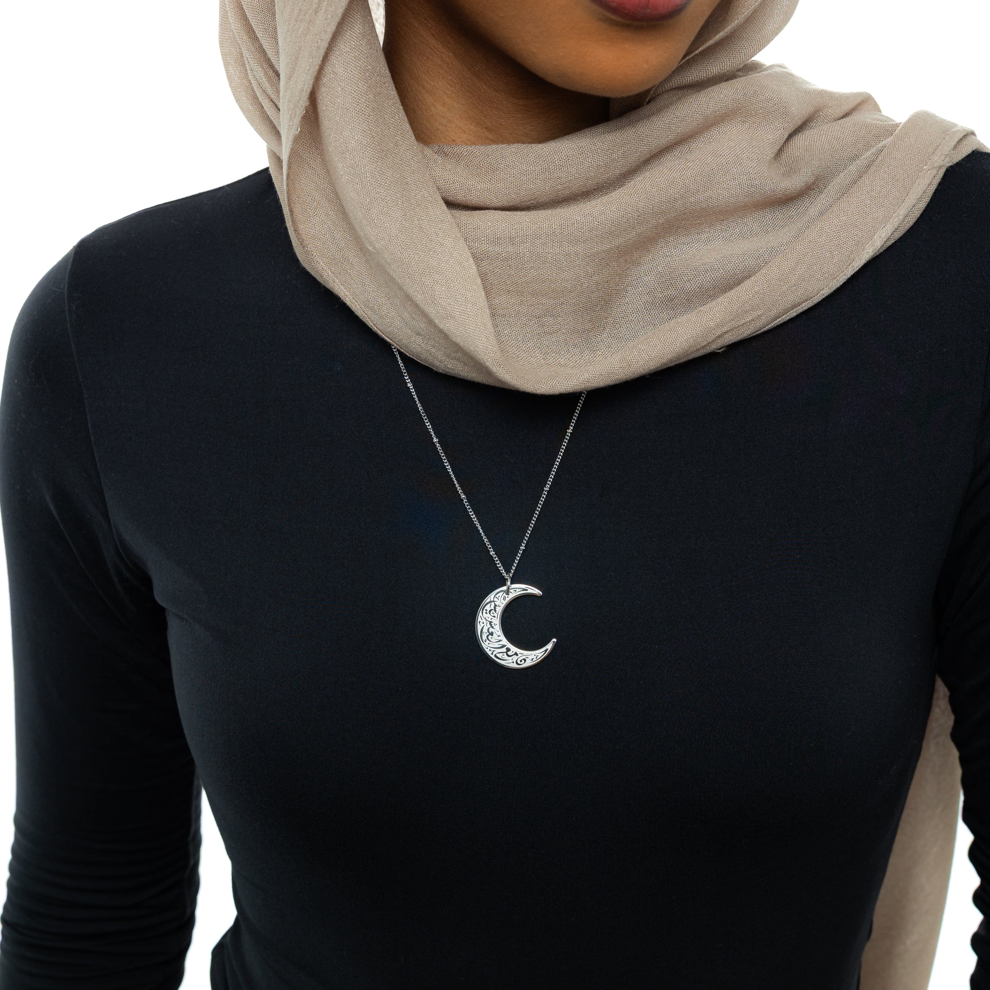 Close-up of the Crescent of Resilience Necklace showcasing the intricate details of the Quranic verse.