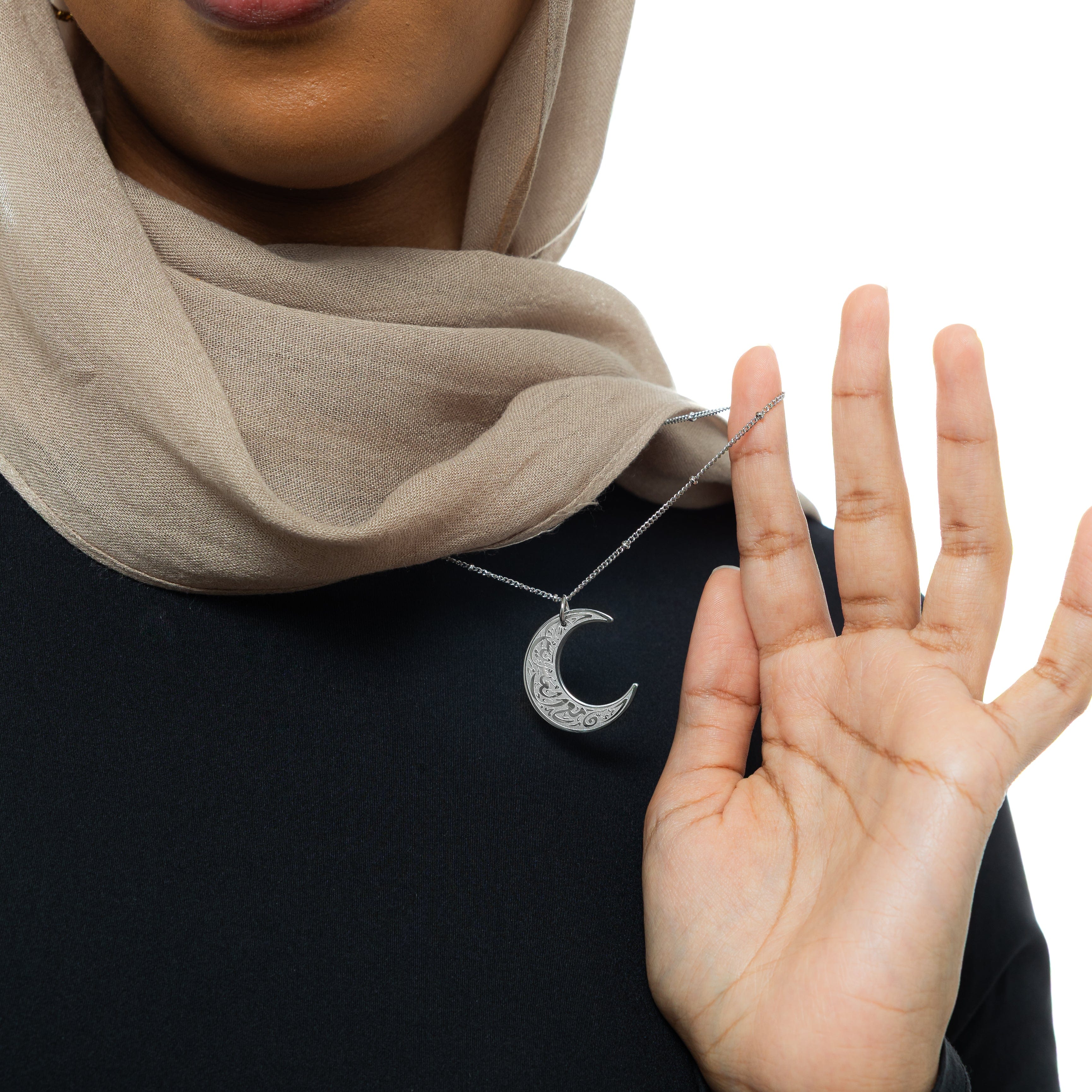 Crescent of Resilience Necklace displayed in a velvet pouch, emphasizing its thoughtful packaging.