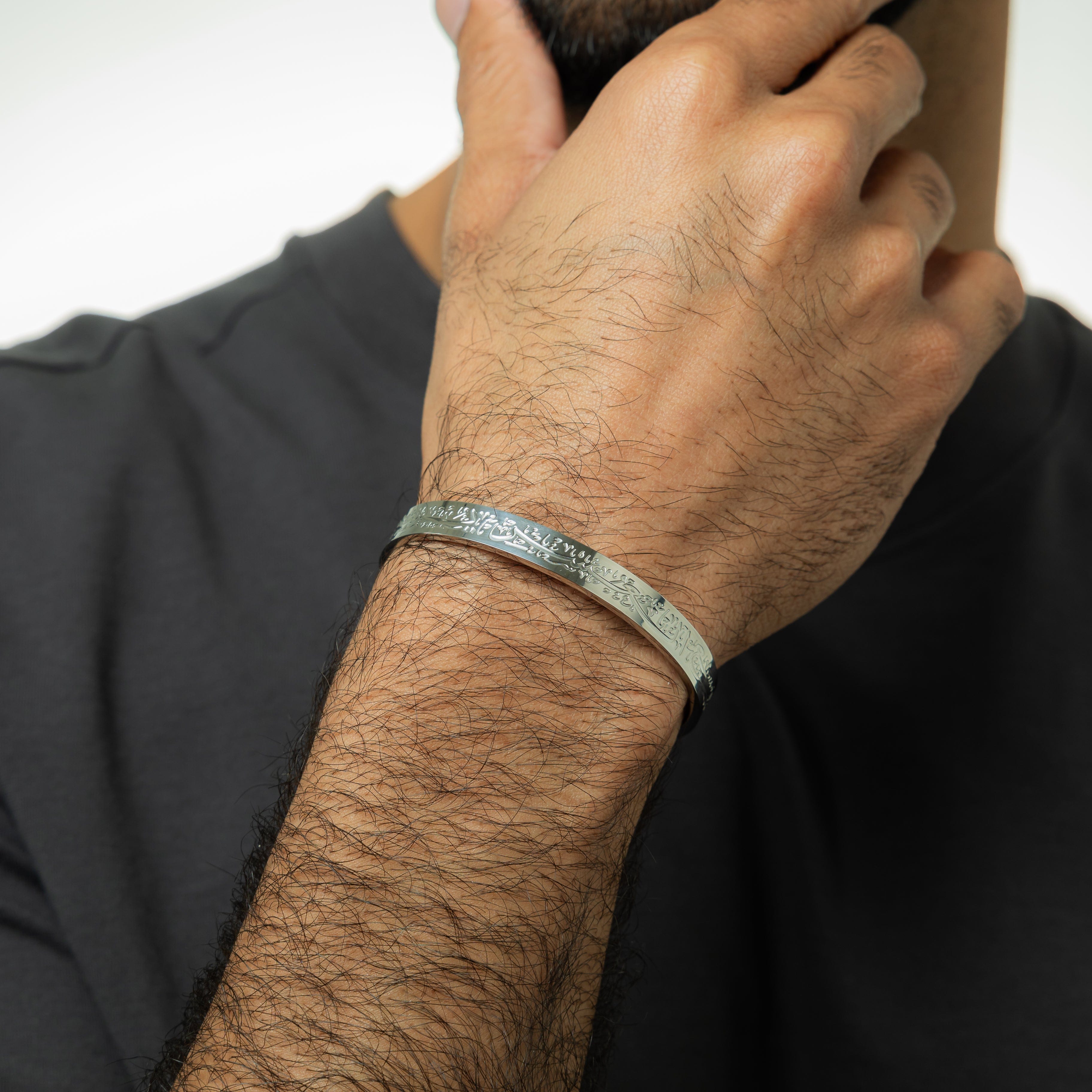 Close-up of the calligraphy design on the adjustable cuff bracelet