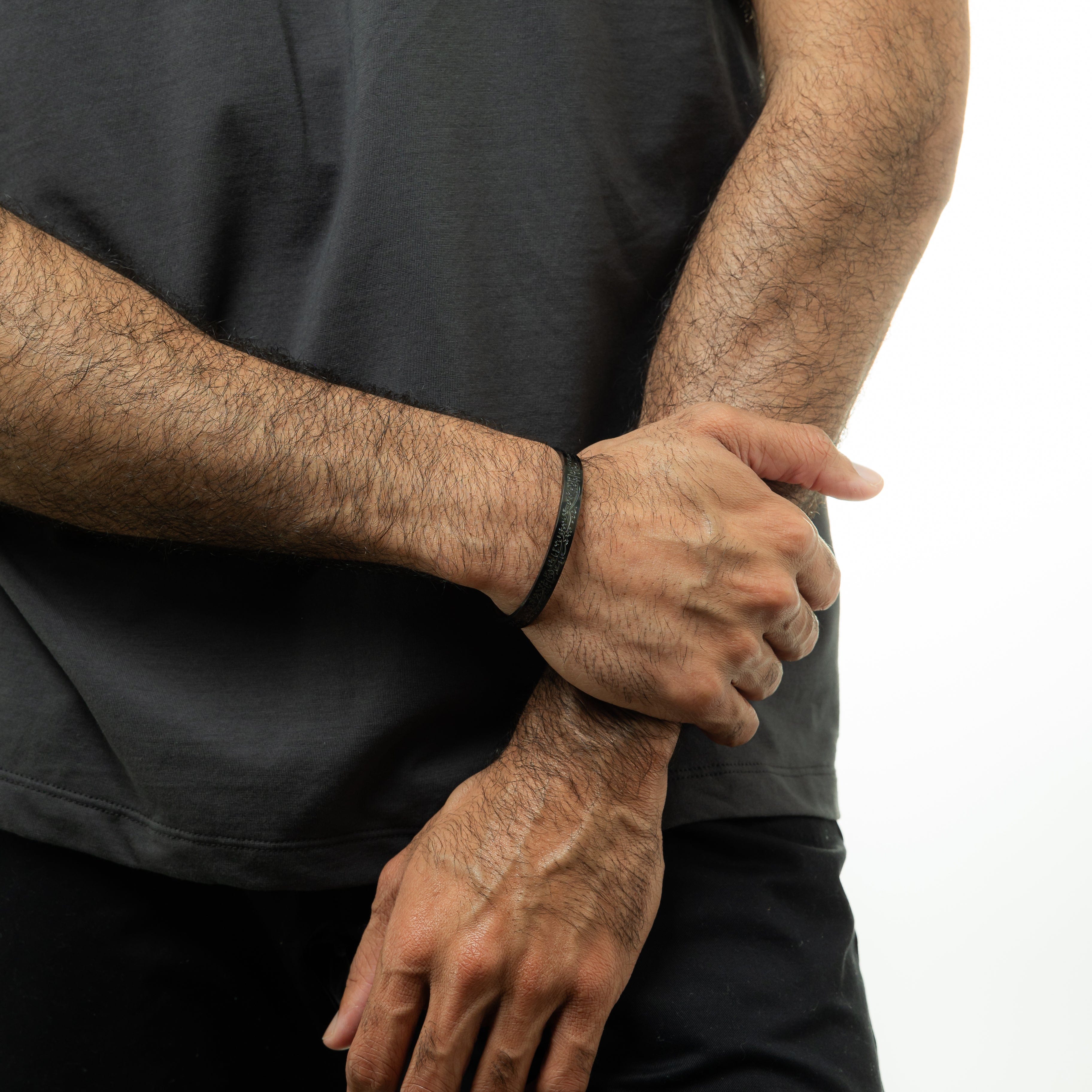 Close-up of the calligraphy design on the adjustable cuff bracelet