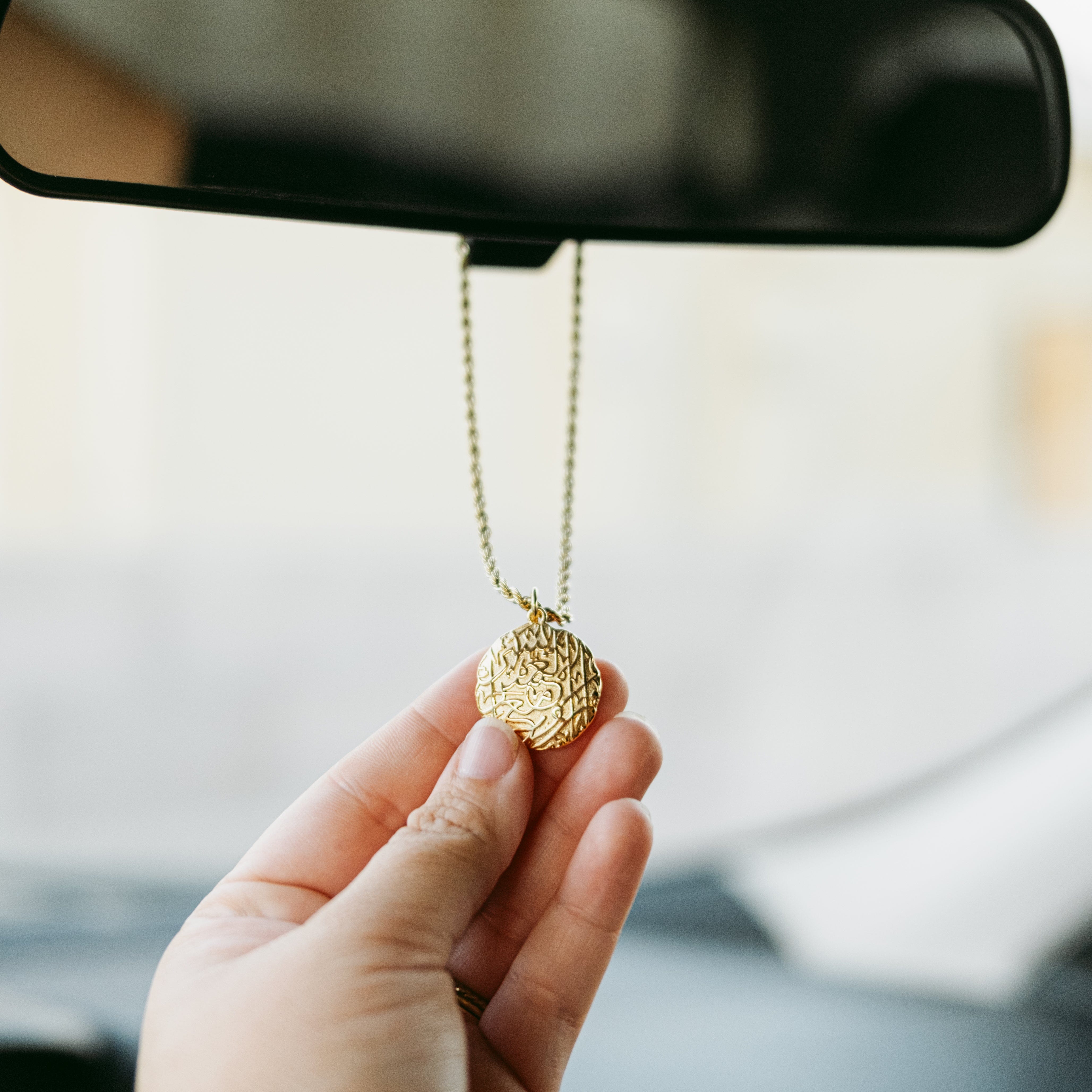 Vintage car hanger displayed in a car interior, highlighting its elegant design.