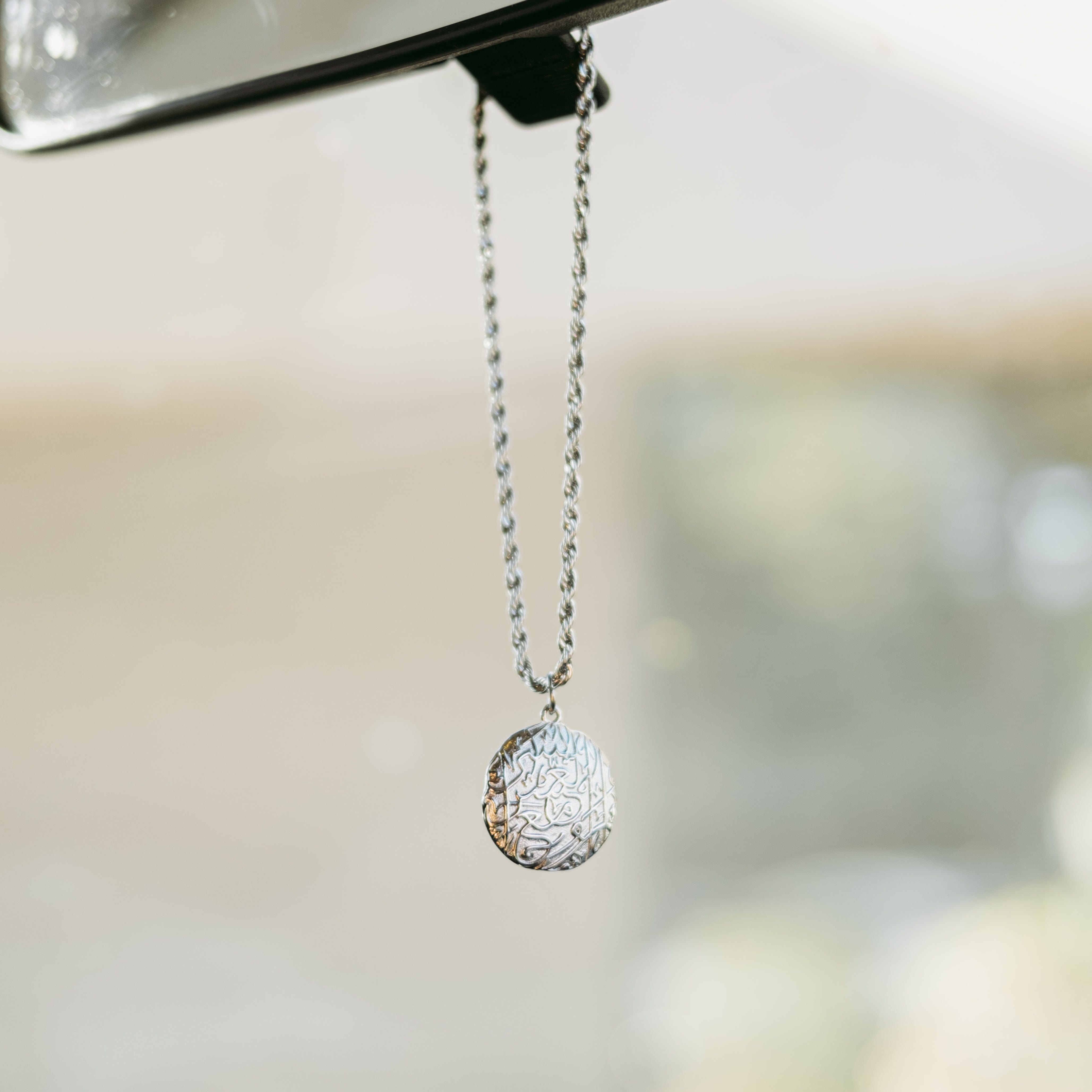 Packaging of the vintage car hanger in a soft velvet pouch, perfect for gifting.
