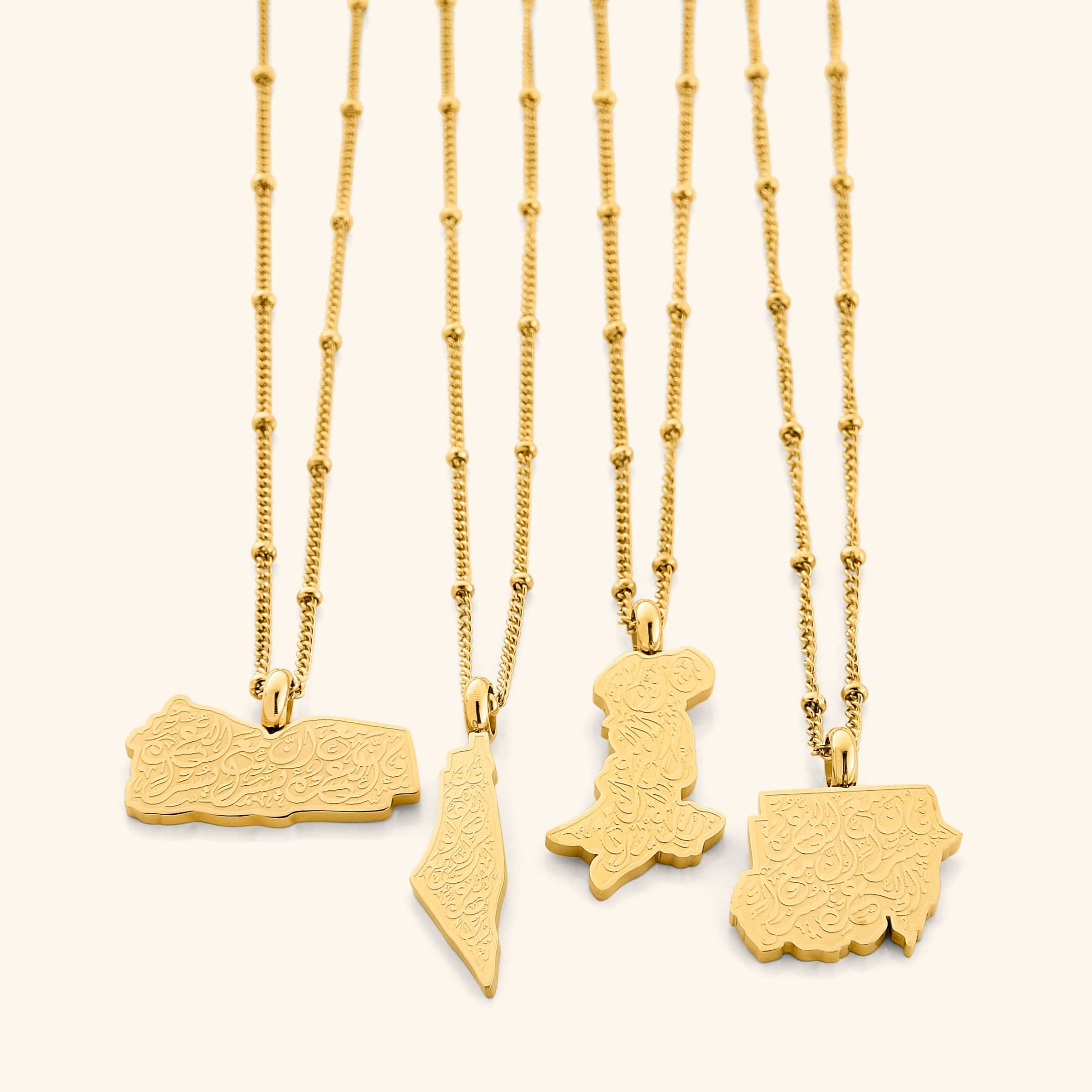 Close-up of Resilient Journey engraved gold necklace showing inscription