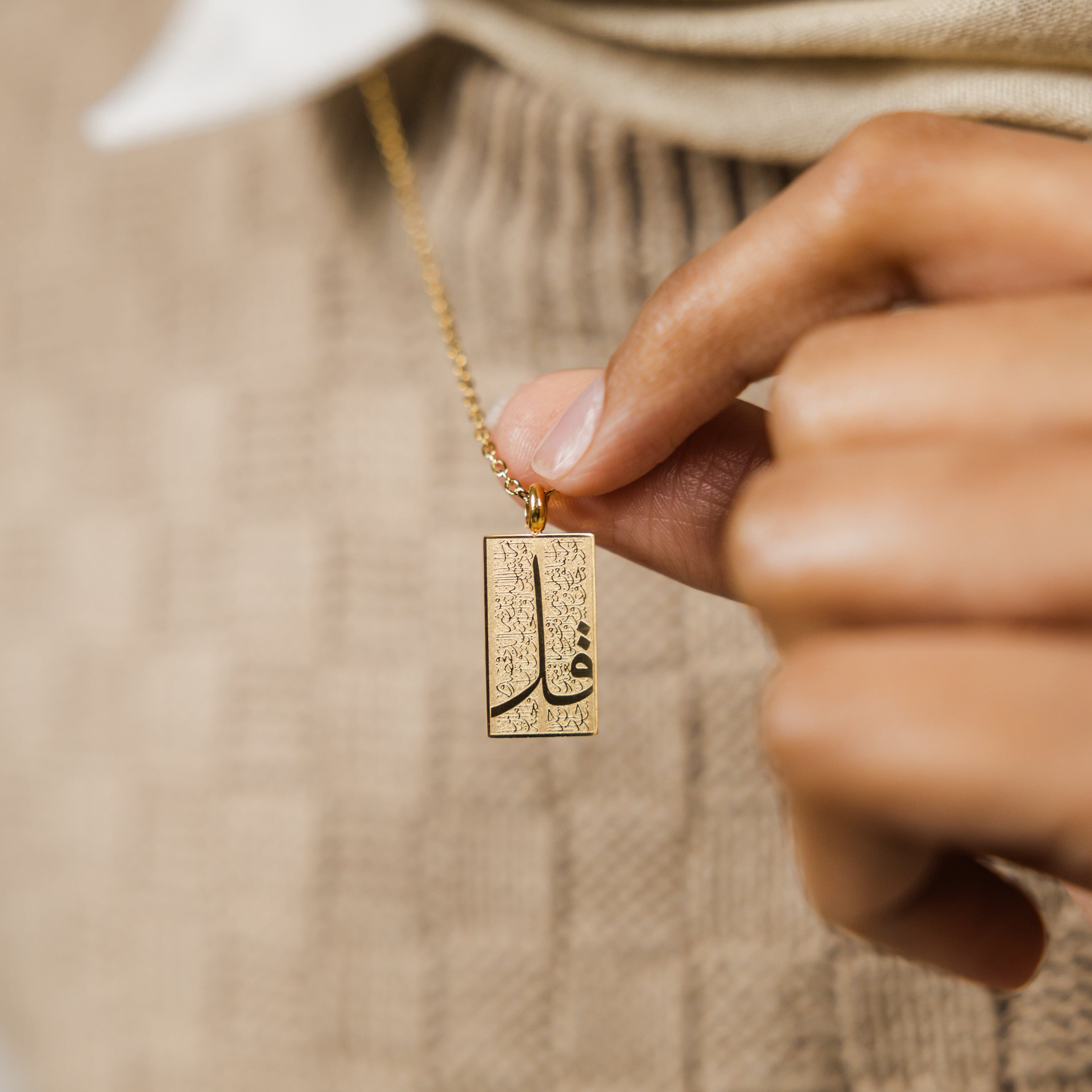 Model wearing the waterproof Quran necklace, displaying its adjustable length and elegance