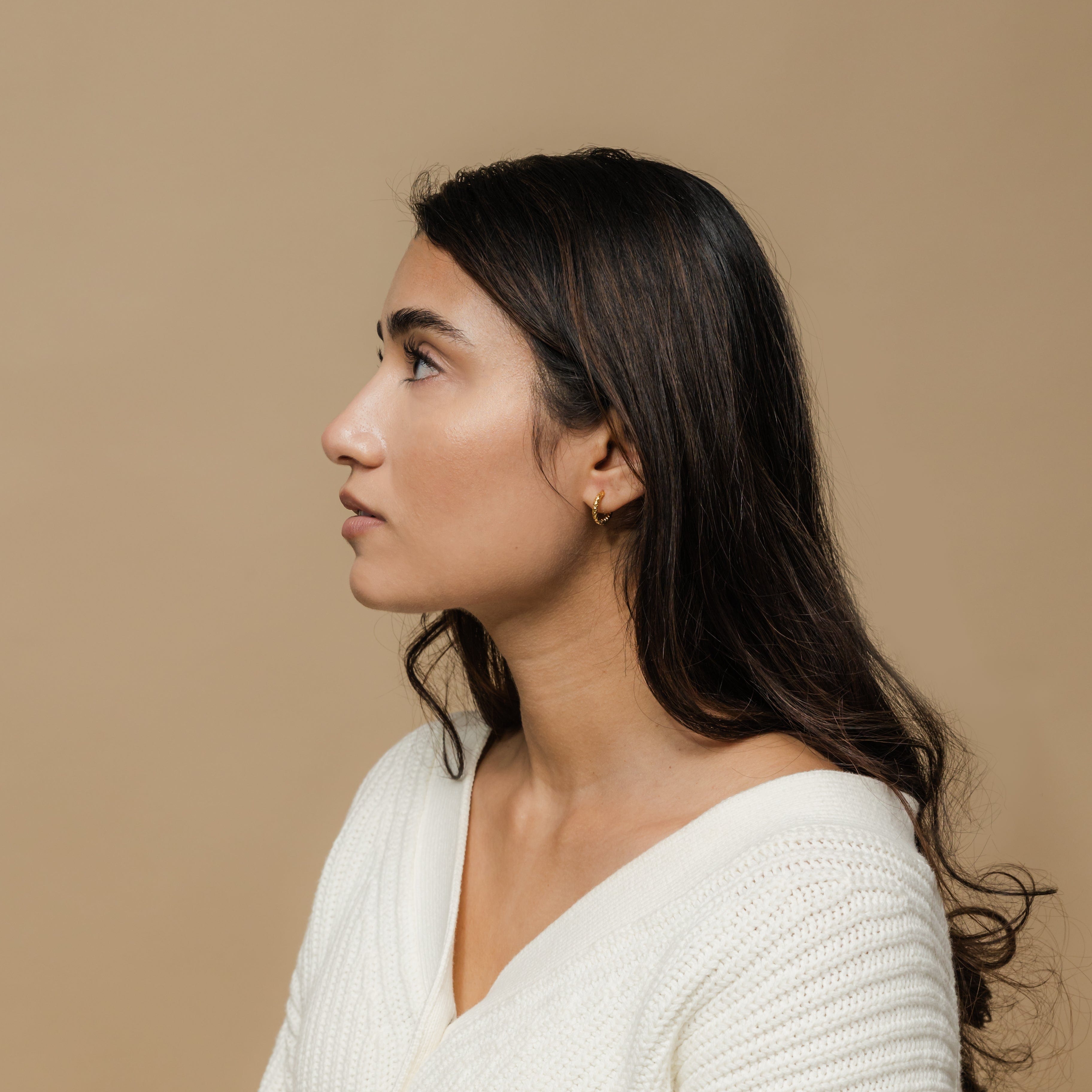 Vintage Glow Gold Hoops displayed in a velvet pouch, highlighting their elegant design.