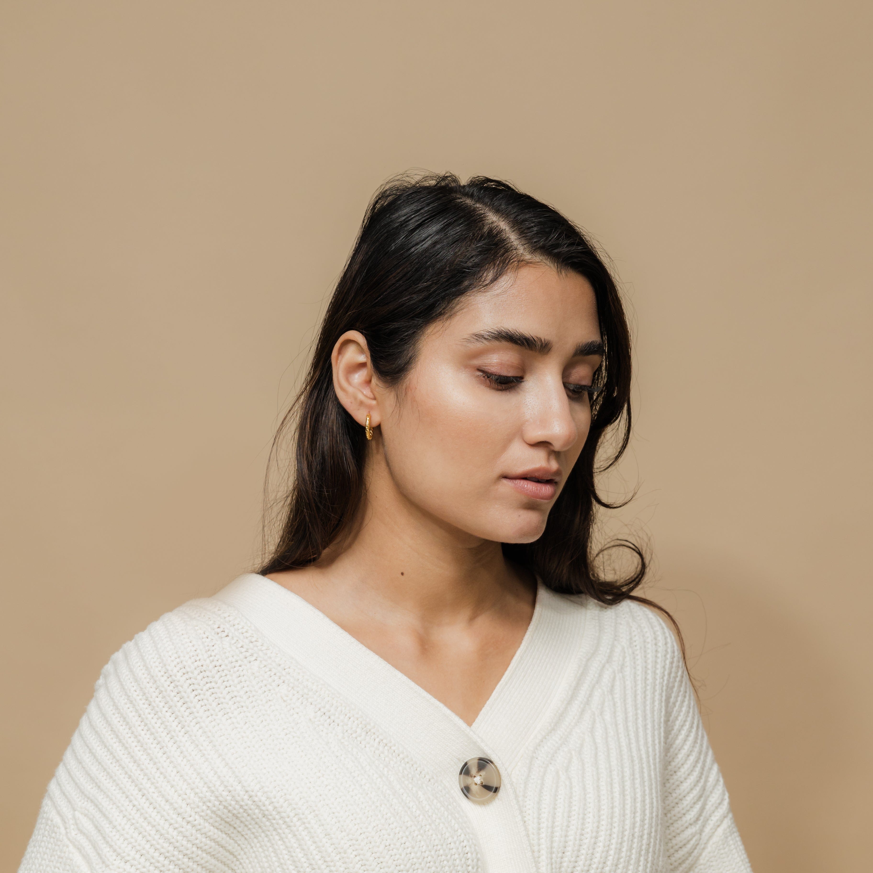 Vintage Glow Gold Hoops displayed in a velvet pouch, highlighting their elegant design.