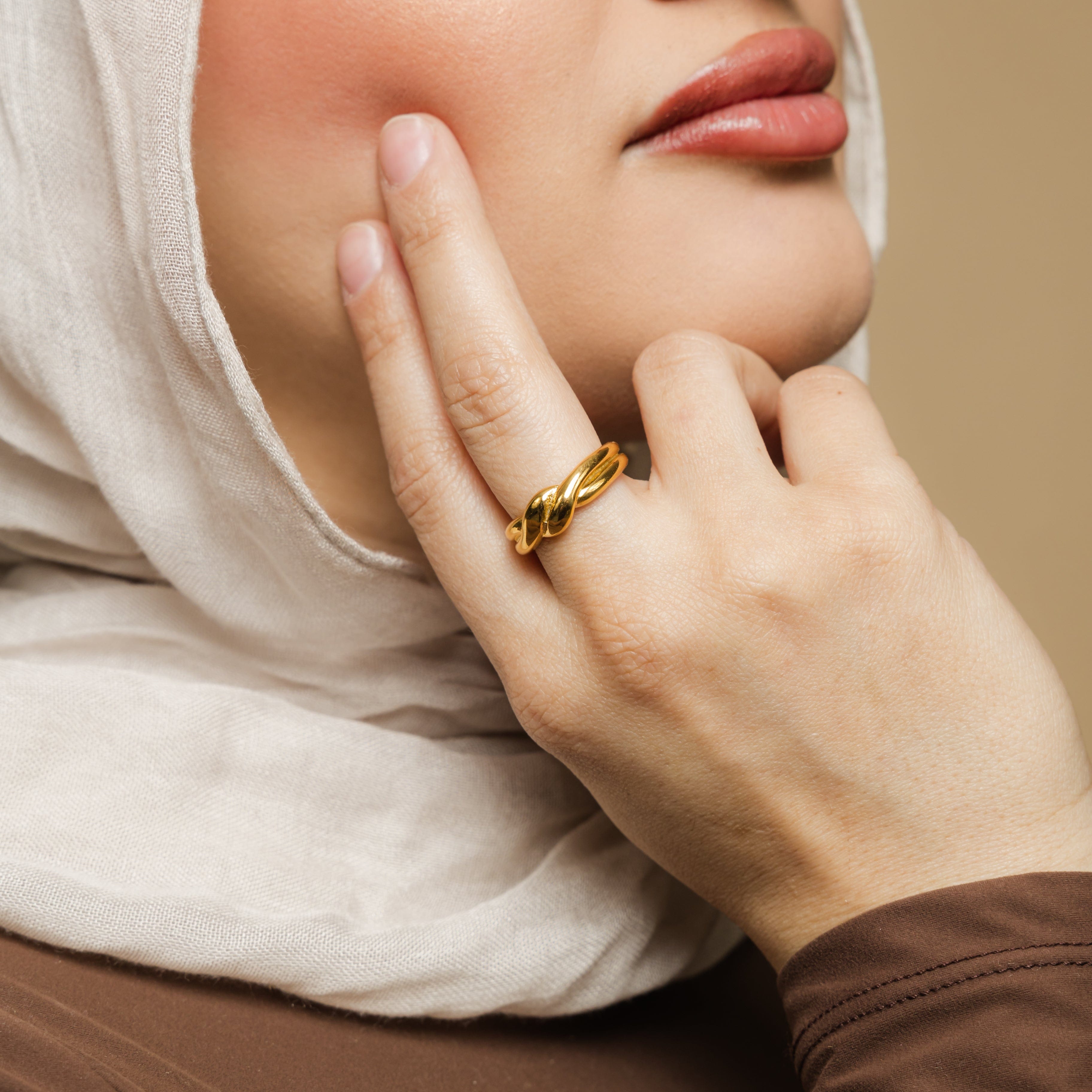 Couple wearing the knot ring, symbolizing their everlasting commitment.