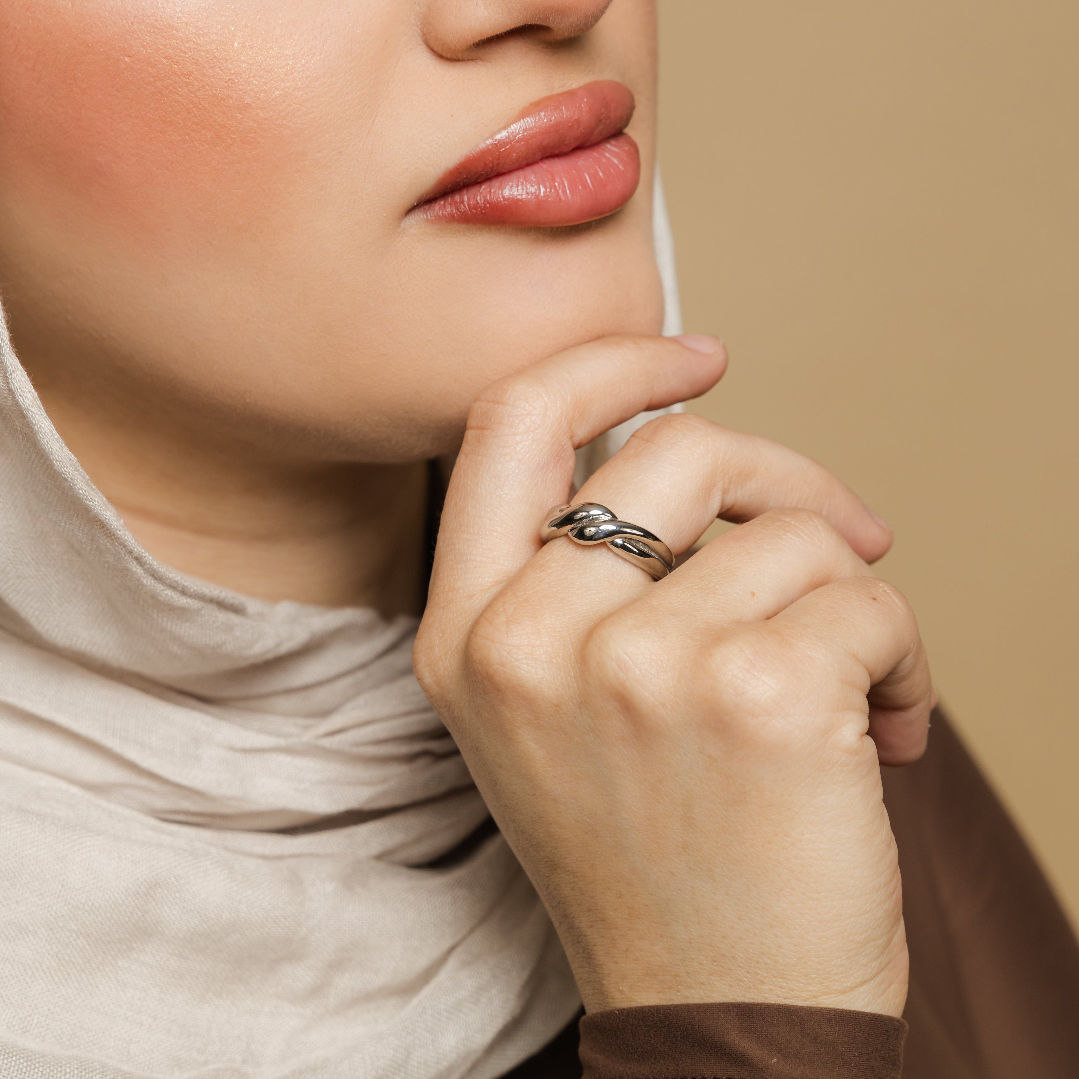 The knot ring displayed in a velvet pouch, emphasizing its elegant packaging.