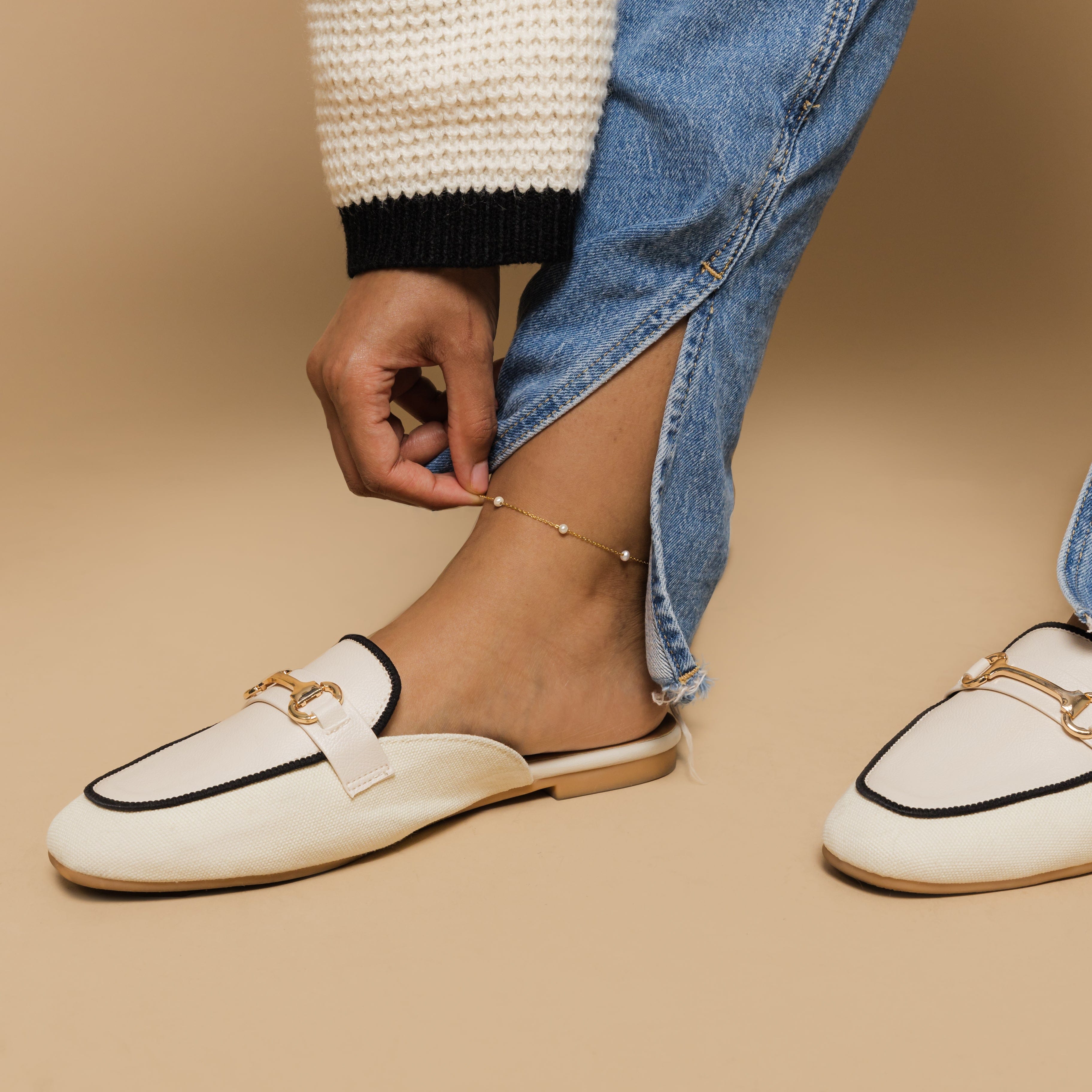 Close-up of an elegant pearl strand anklet showcasing fresh water pearls and gold plating.