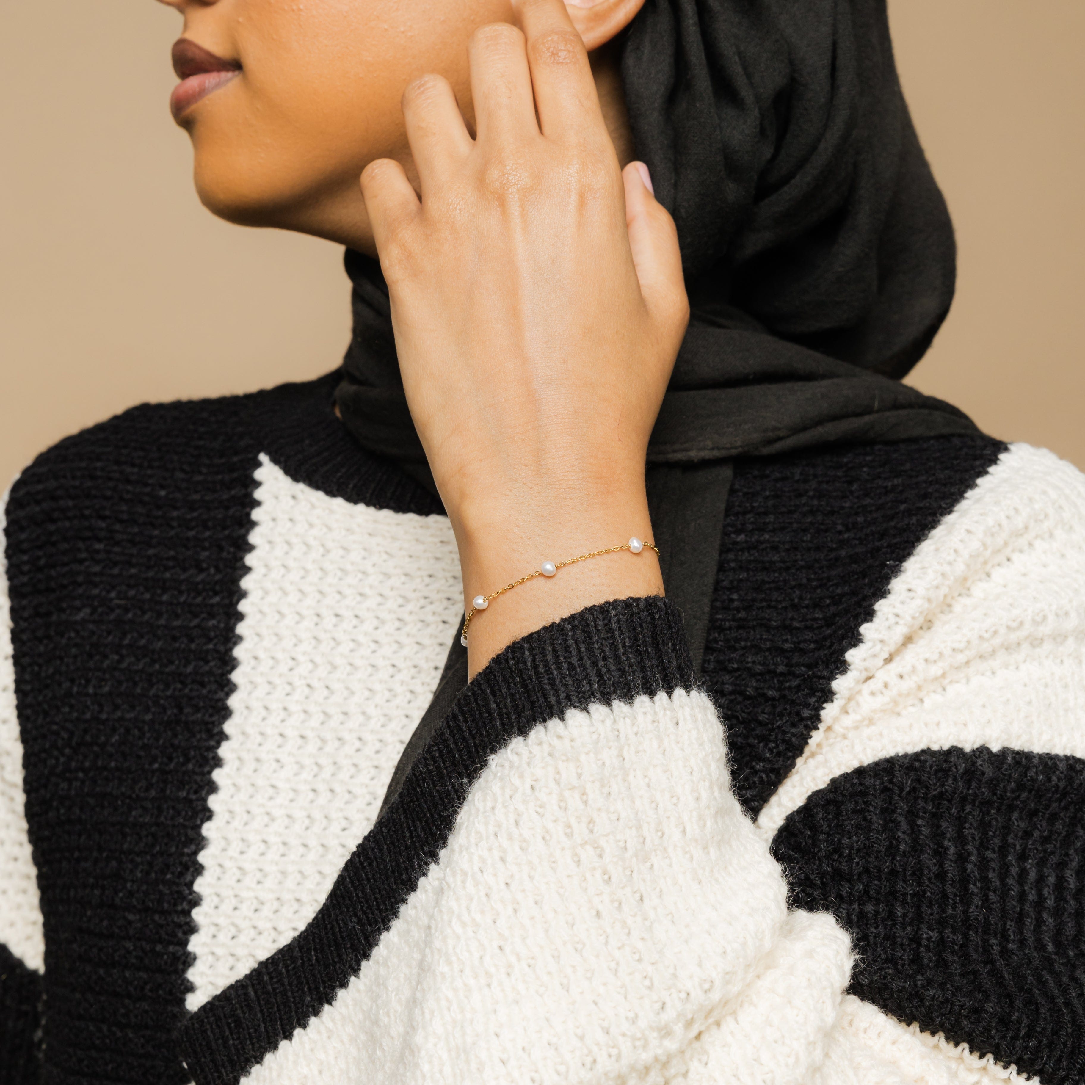 Close-up of the pearl strand bracelet showcasing the 18K gold plating and freshwater pearls.