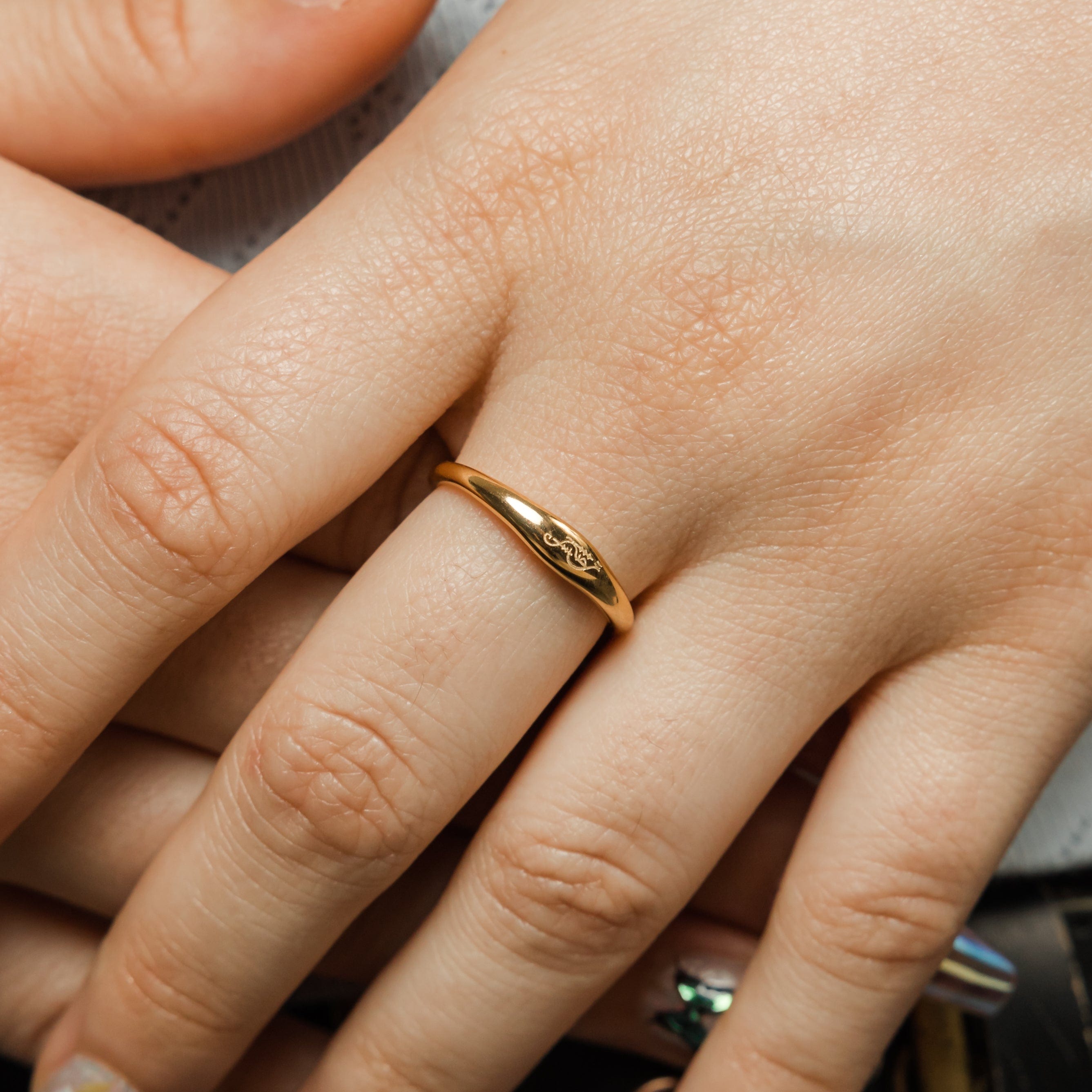 Close-up of the sisterhood signet ring showcasing Arabic calligraphy.