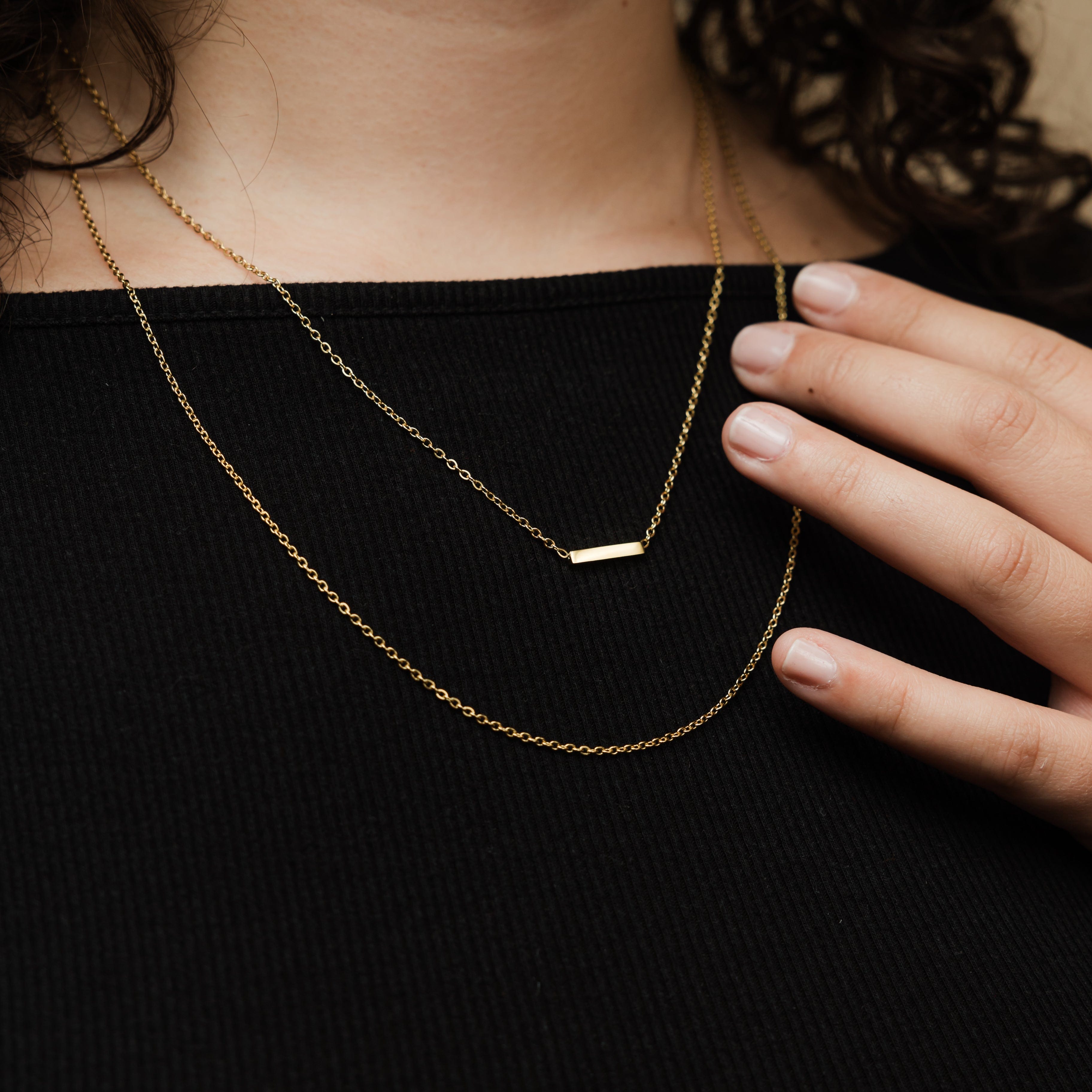 Gold adjustable necklace set displayed on a model showcasing layering options.
