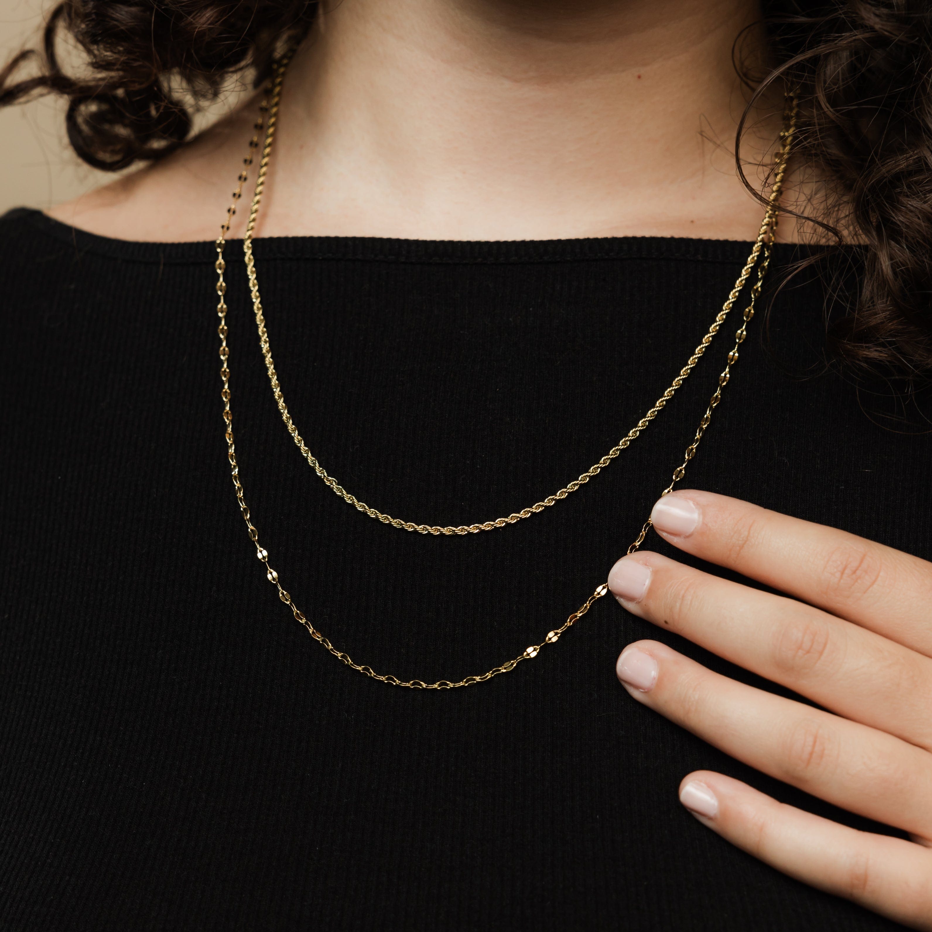 Both chains layered together, showcasing versatility in style