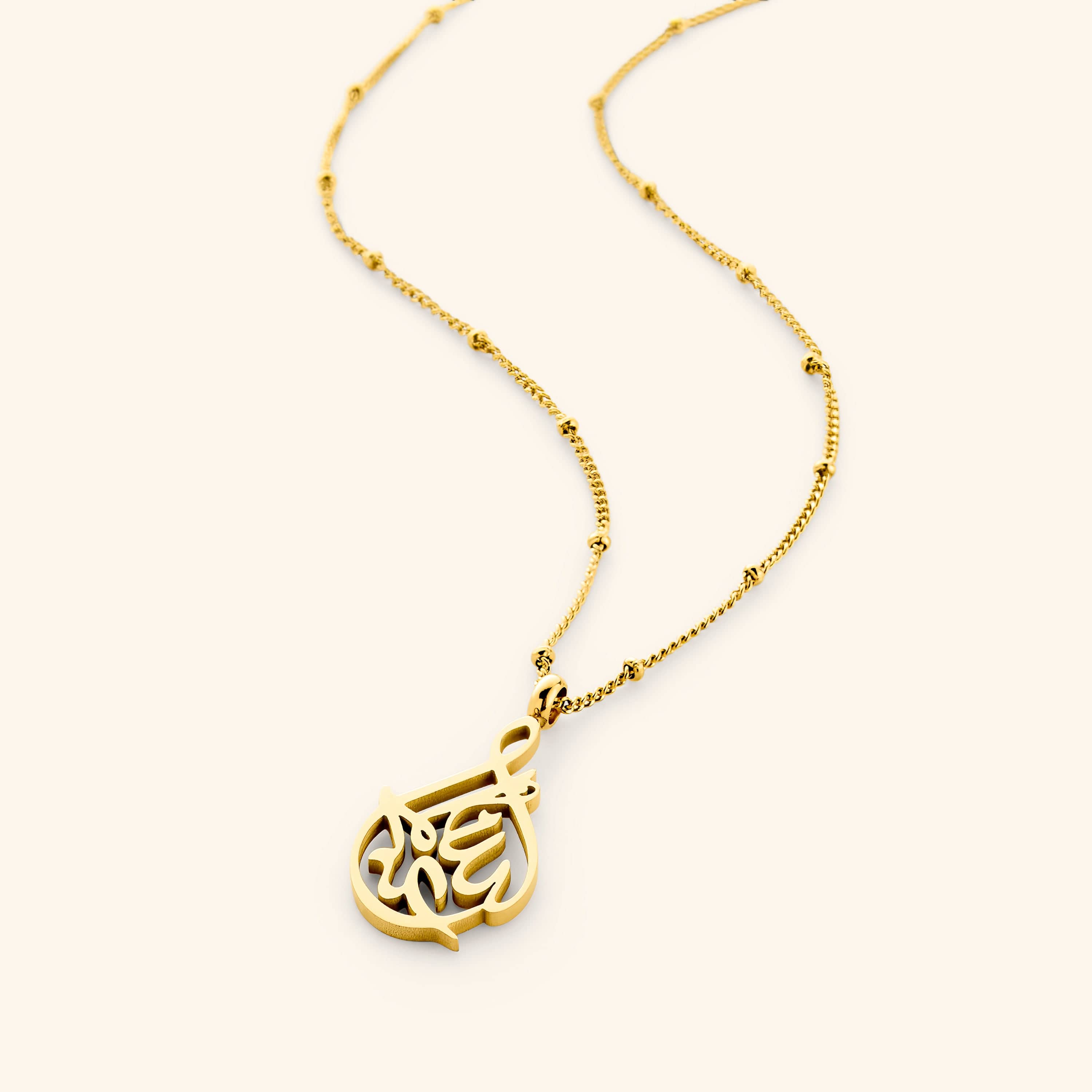 Alhamdulillah calligraphy necklace displayed elegantly on a white background.