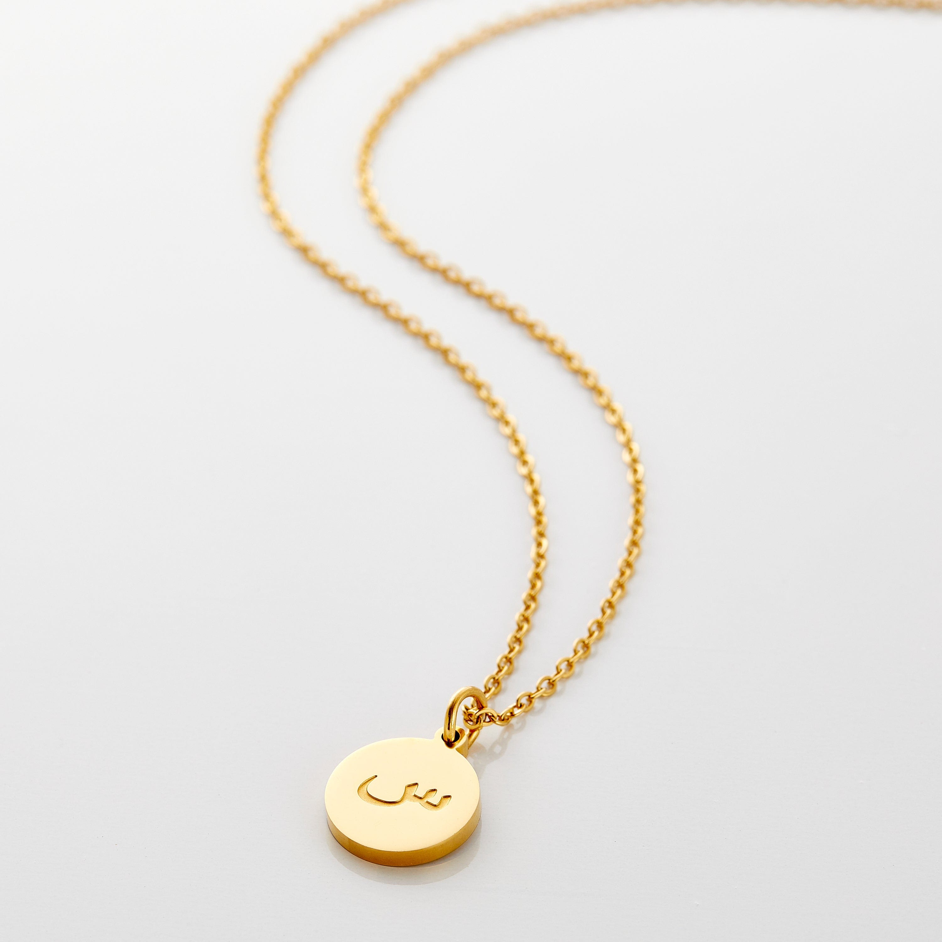 Close-up view of the elegant Arabic letter necklace showcasing the intricate engraving.