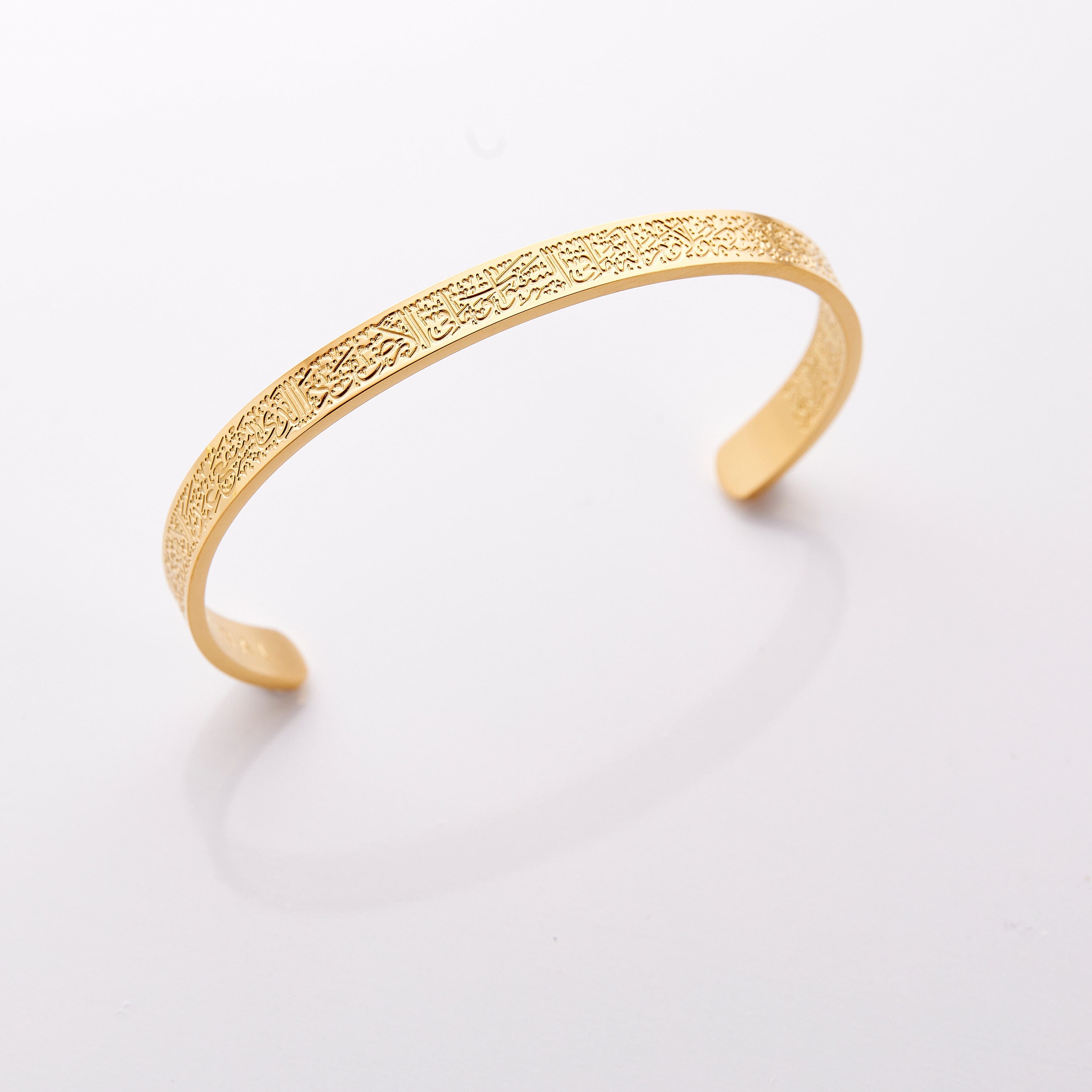 Ayatul Kursi cuff on a girl's wrist, showcasing its stylish design and meaningful inscription.