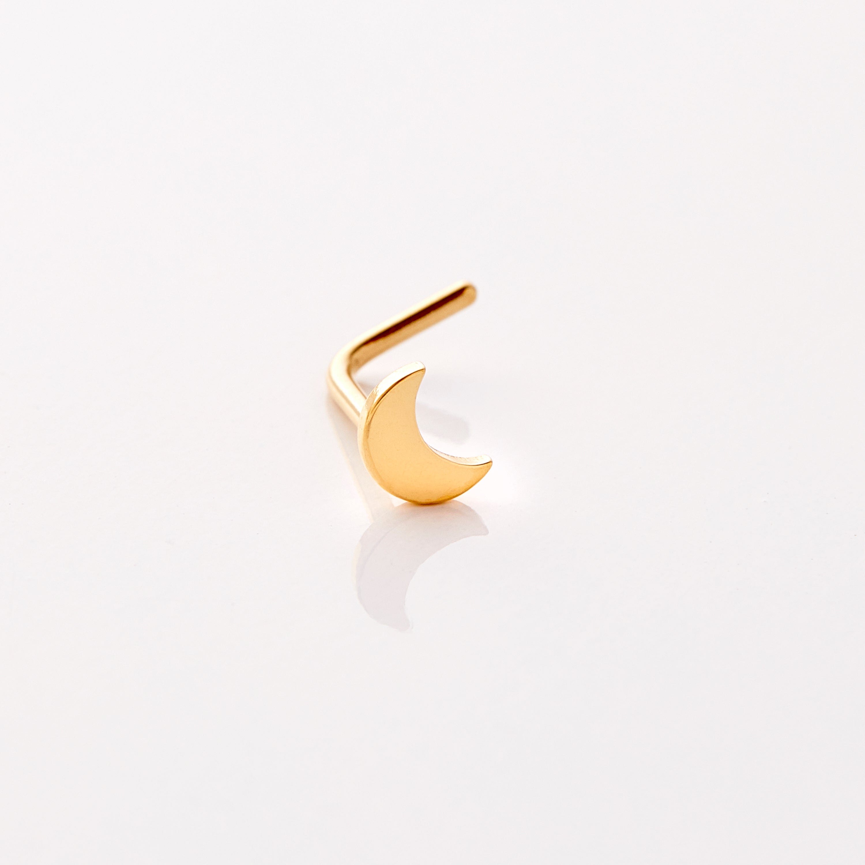 Close-up view of the Lunar Luxe nose stud showcasing its gold finish and design.