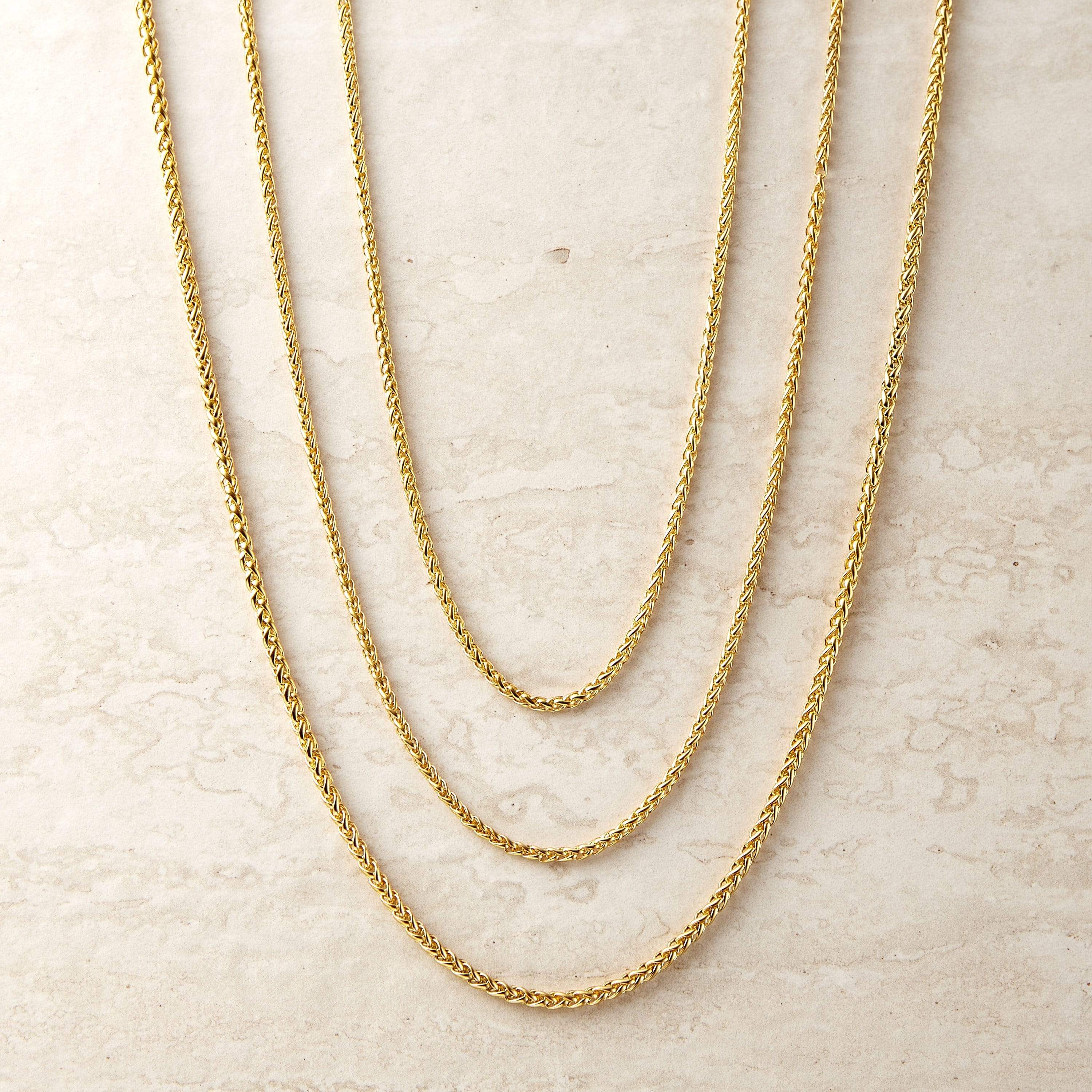Close-up of the elegant wheat chain necklace showing its woven design and adjustable length