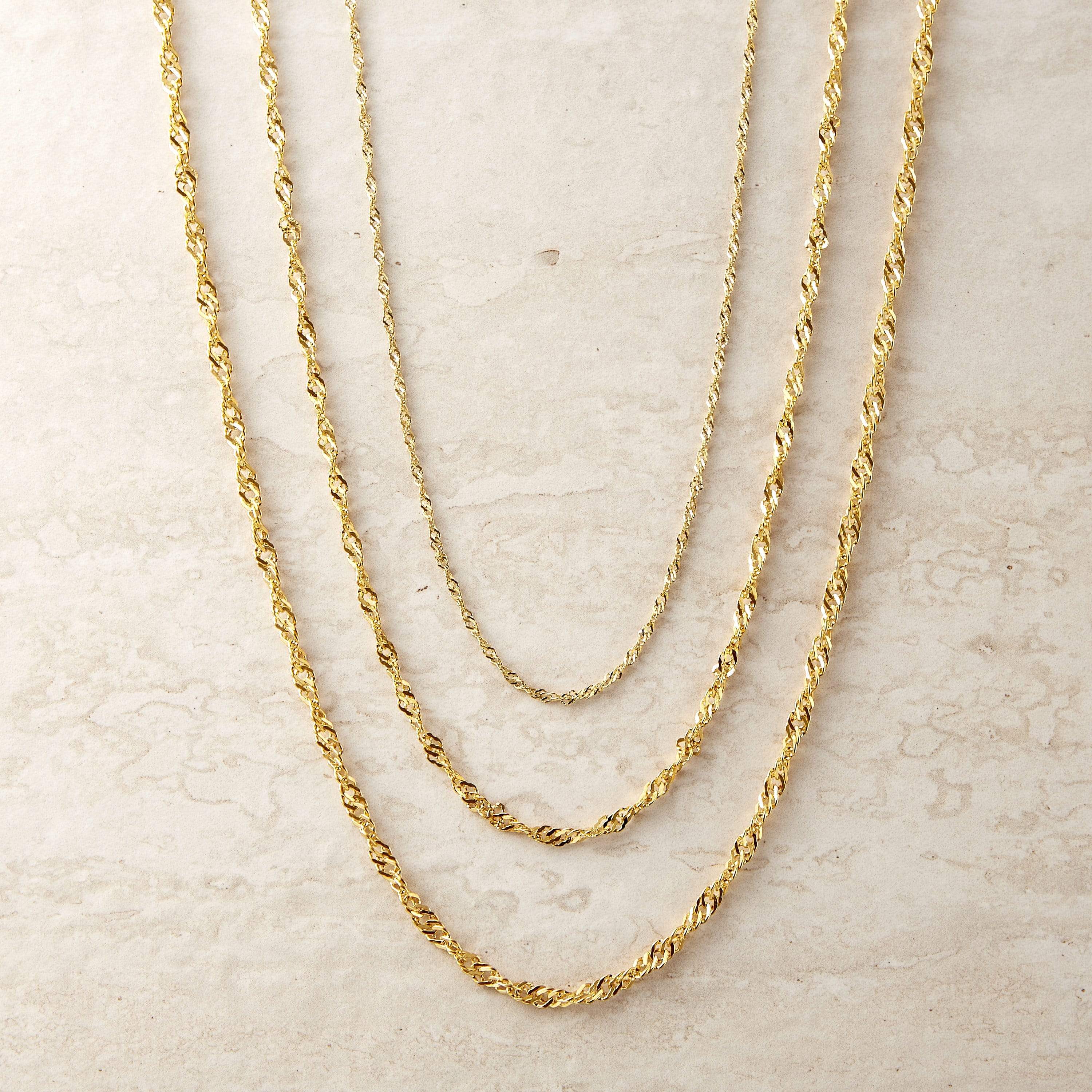 Elegant twisted gold chain necklace displayed on a model at 16 inches.