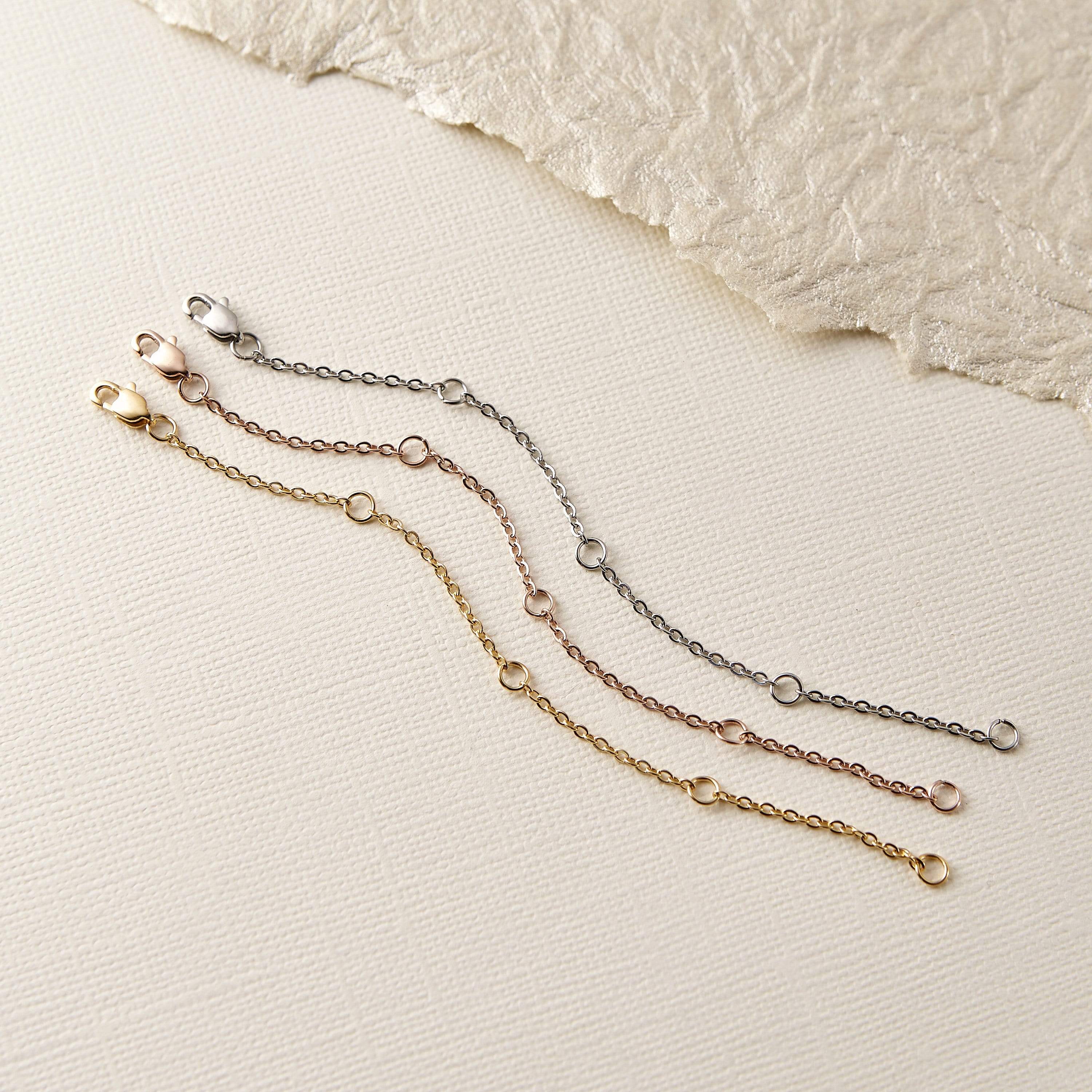 Close-up of the stainless steel chain extender highlighting the clasp mechanism.