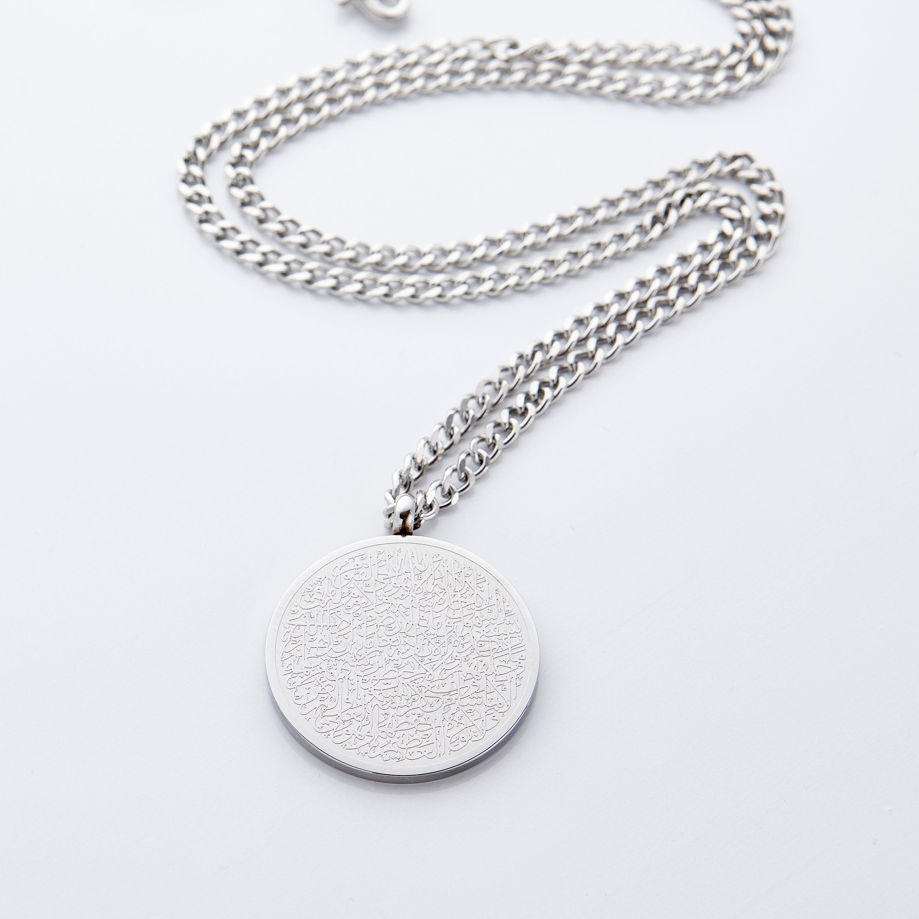 Close-up of the Ayatul Kursi necklace pendant, highlighting the elegant calligraphy.