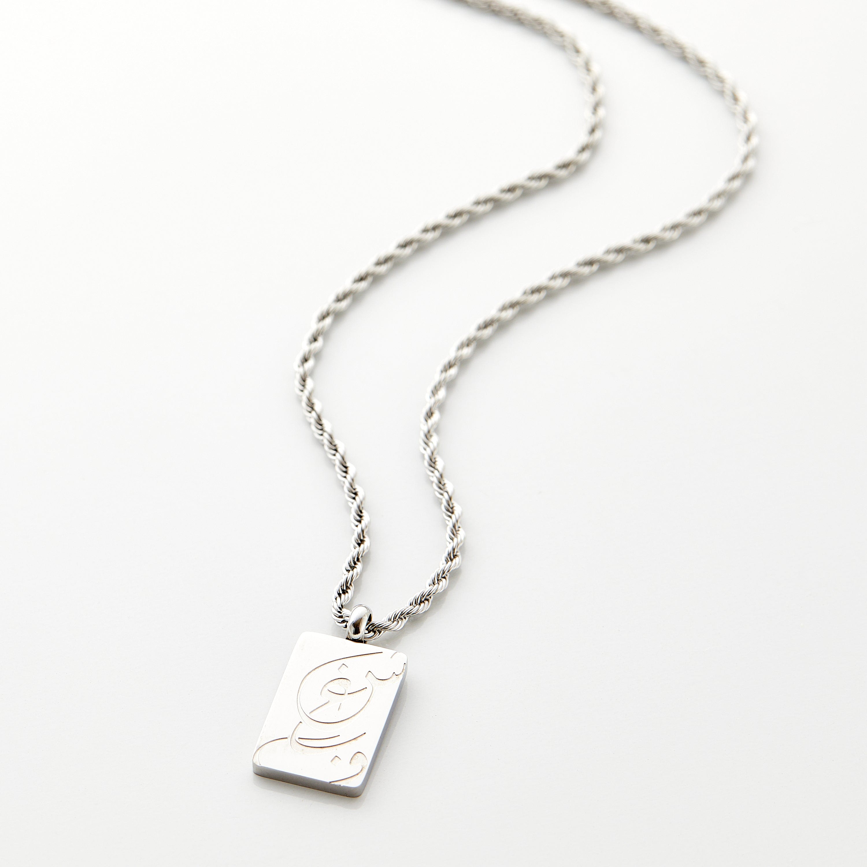 Close-up of the Passion Arabic calligraphy necklace showcasing intricate engraving and sturdy chain.