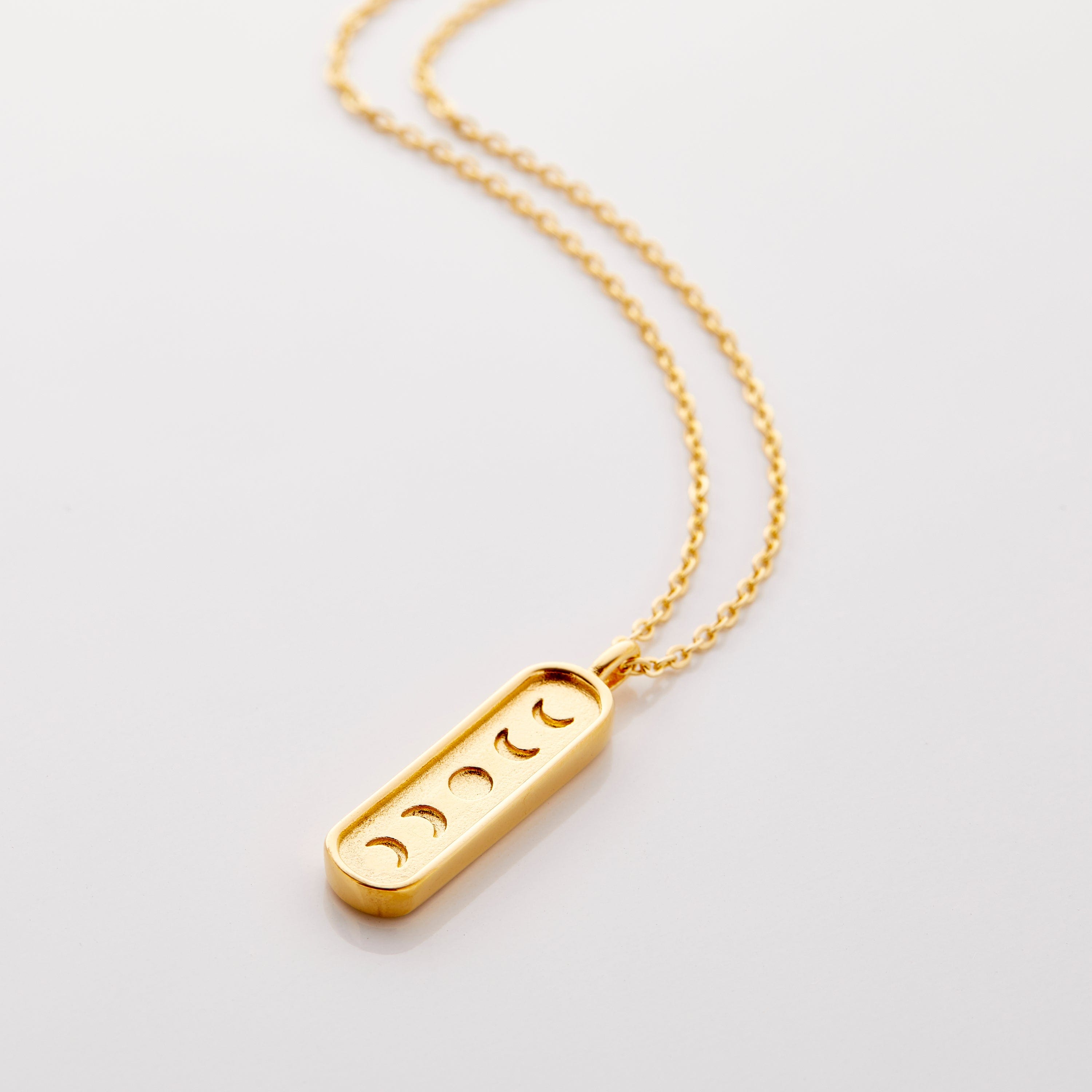 Close-up of the Celestial Phases Moon Necklace highlighting the lunar details.