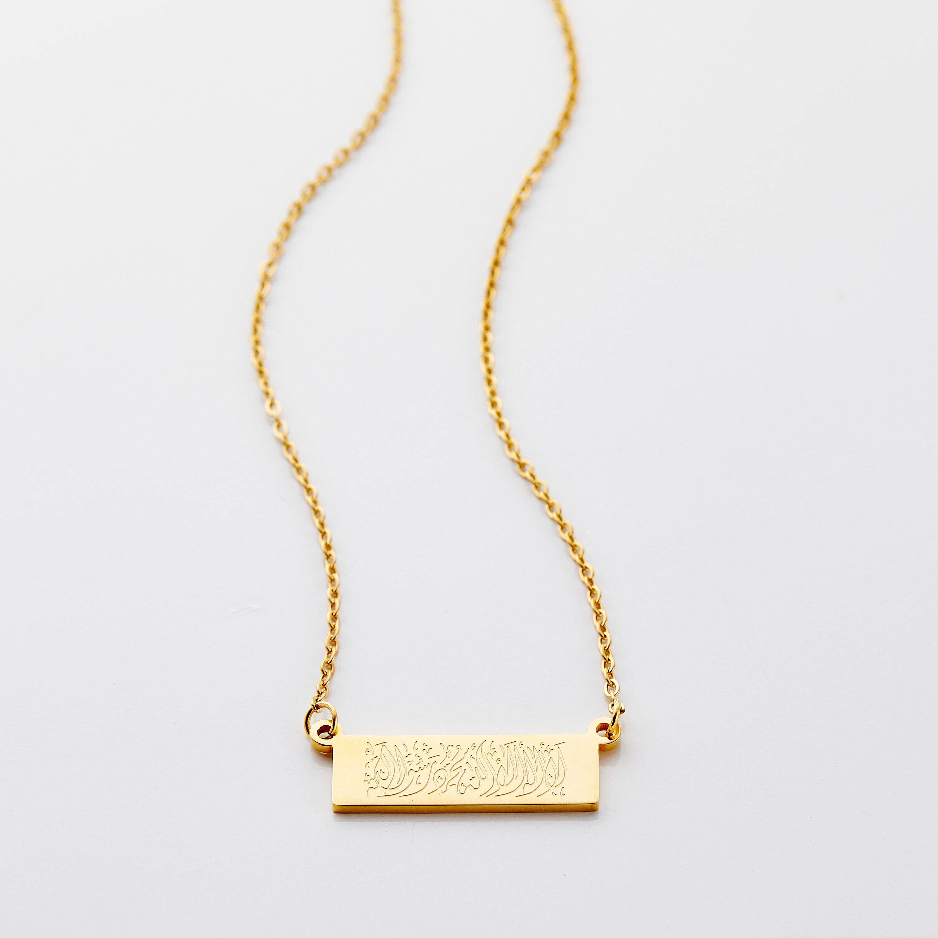Elegant Shahada necklace showcasing exquisite Arabic calligraphy on a gold plated finish.